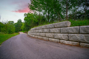 Paved trail and retaining wall at sunset